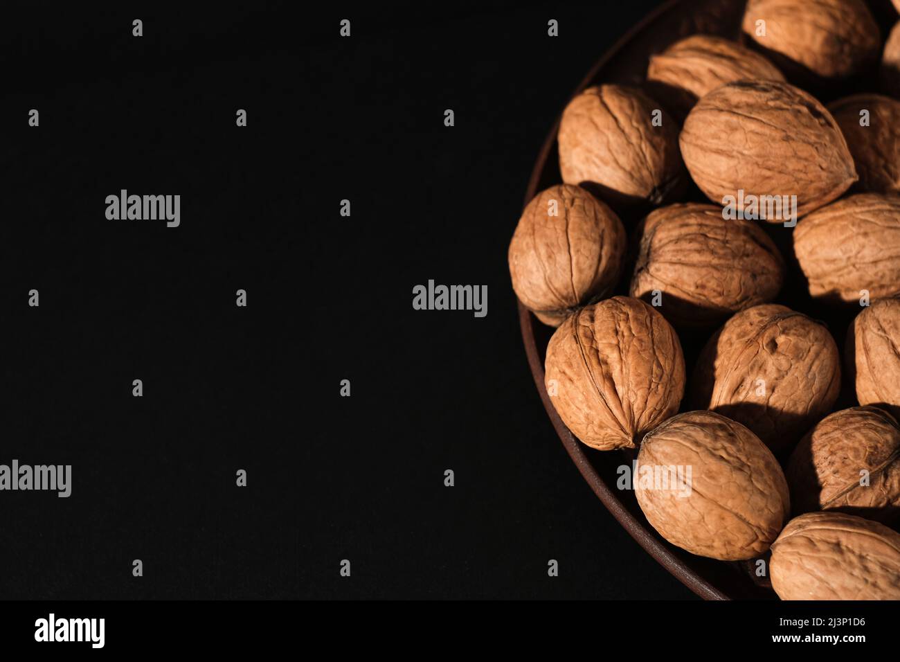 Walnuts on a dark background. Nutcracker close-up. Stock Photo