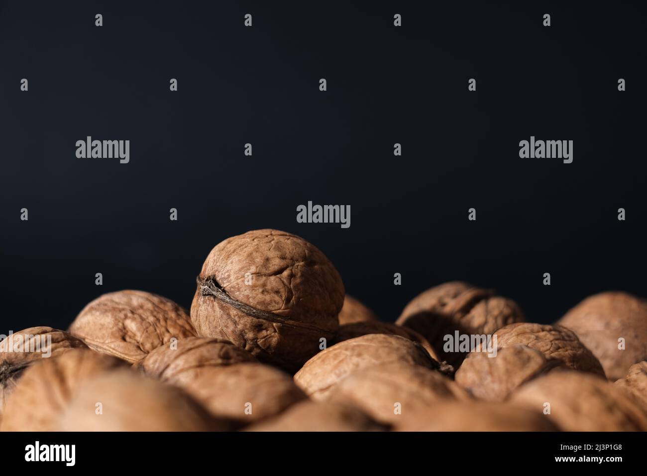 Walnuts on a dark background. Nutcracker close-up. Stock Photo