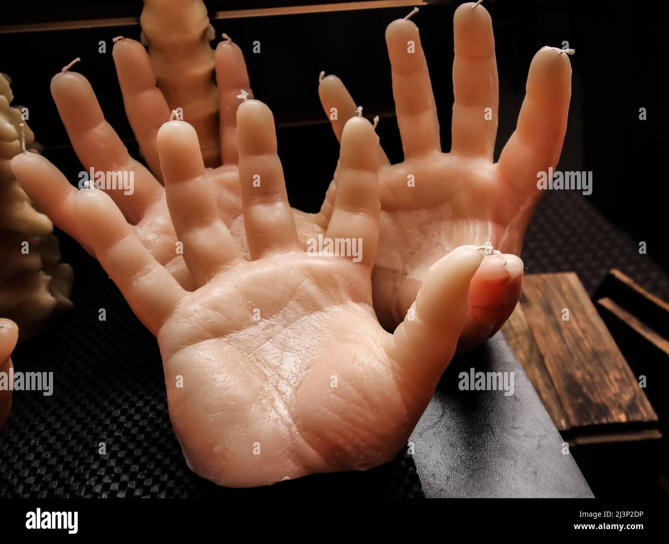 Display Of Human Hands With Wicks At End Of Finders Stock Photo