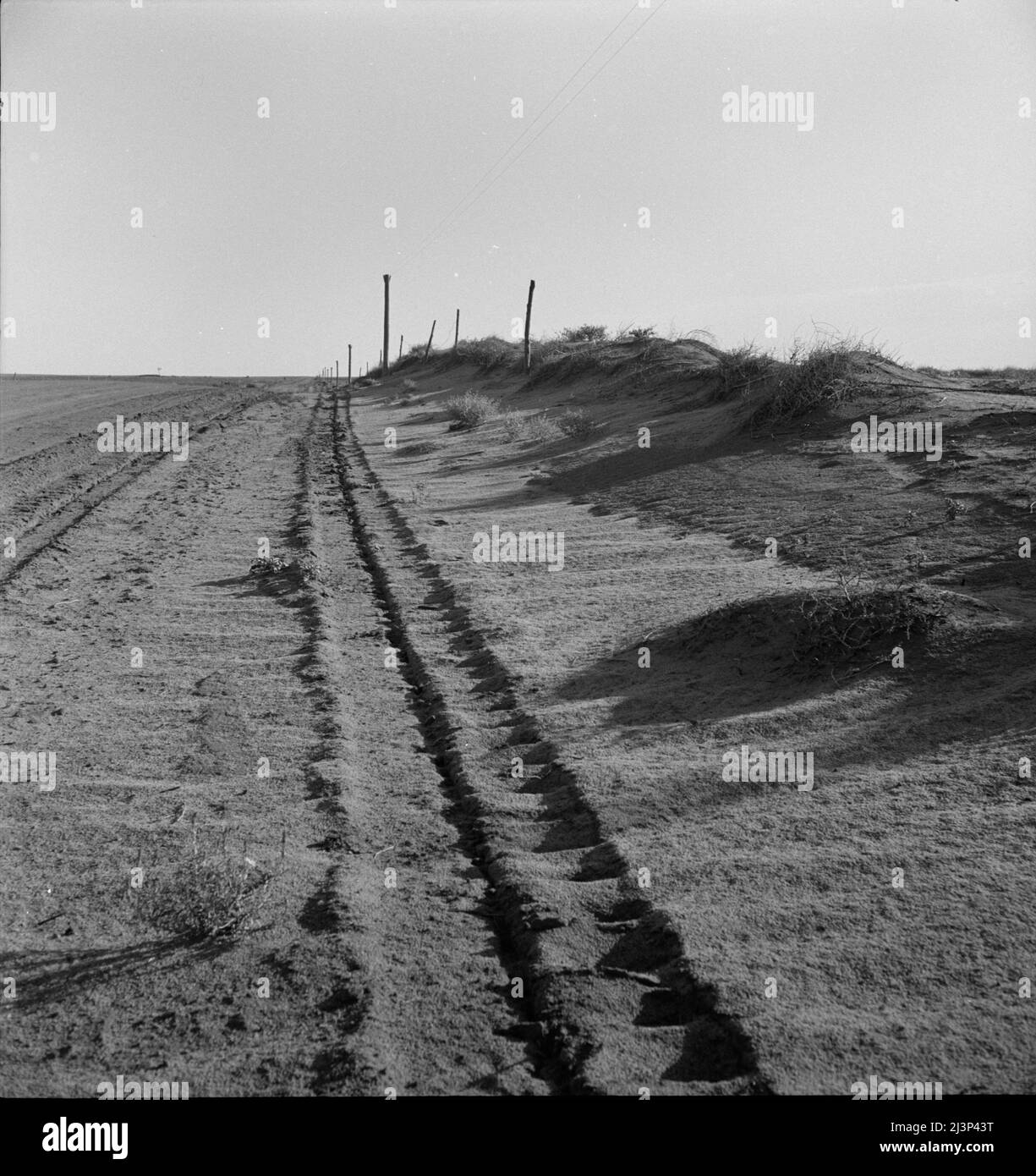 Sand drift along fence. Dust Bowl, north of Dalhart, Texas Stock Photo