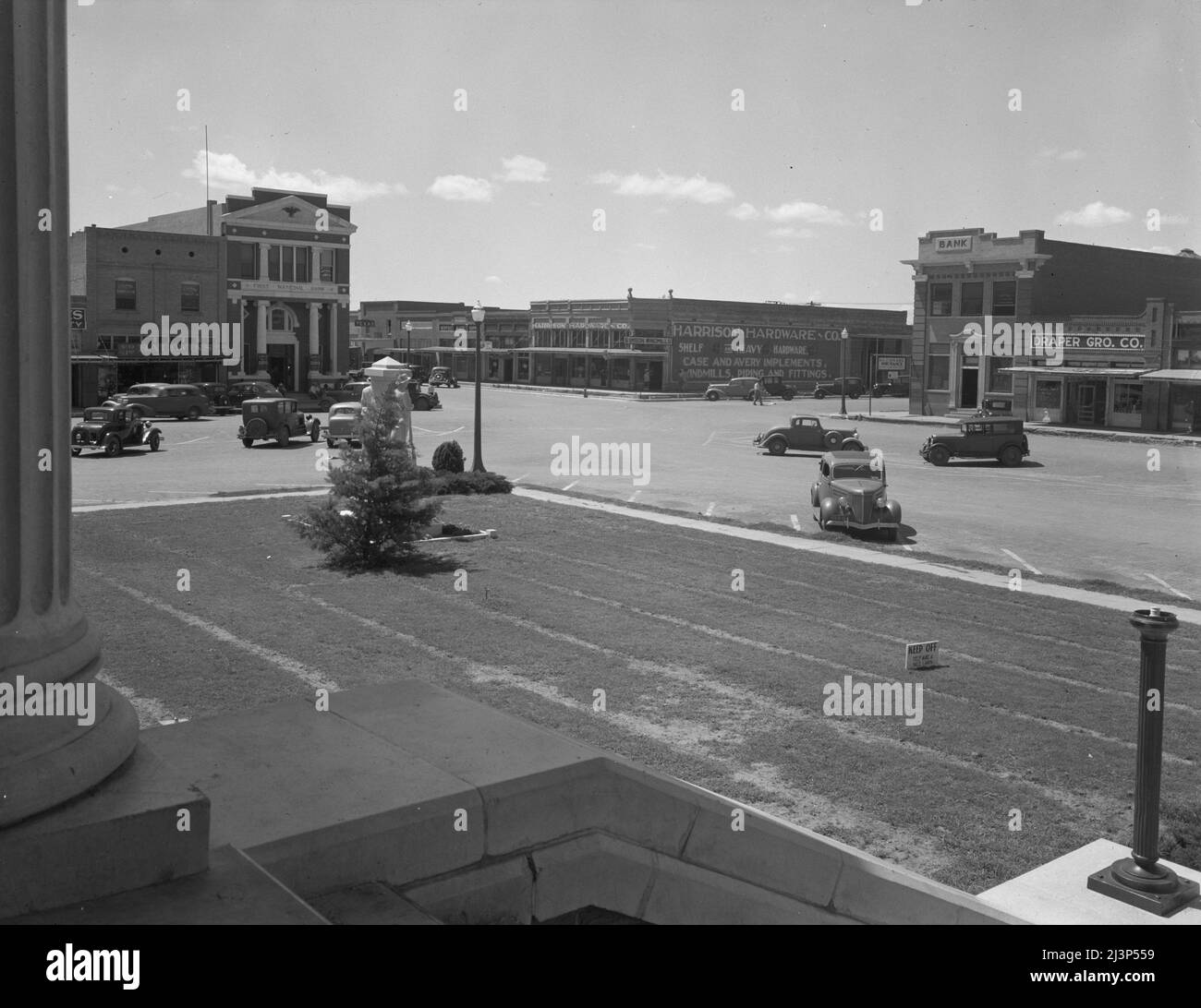 The town square of Memphis, Texas. [First National Bank, Harrison Hardware Co, draper's shop]. Stock Photo