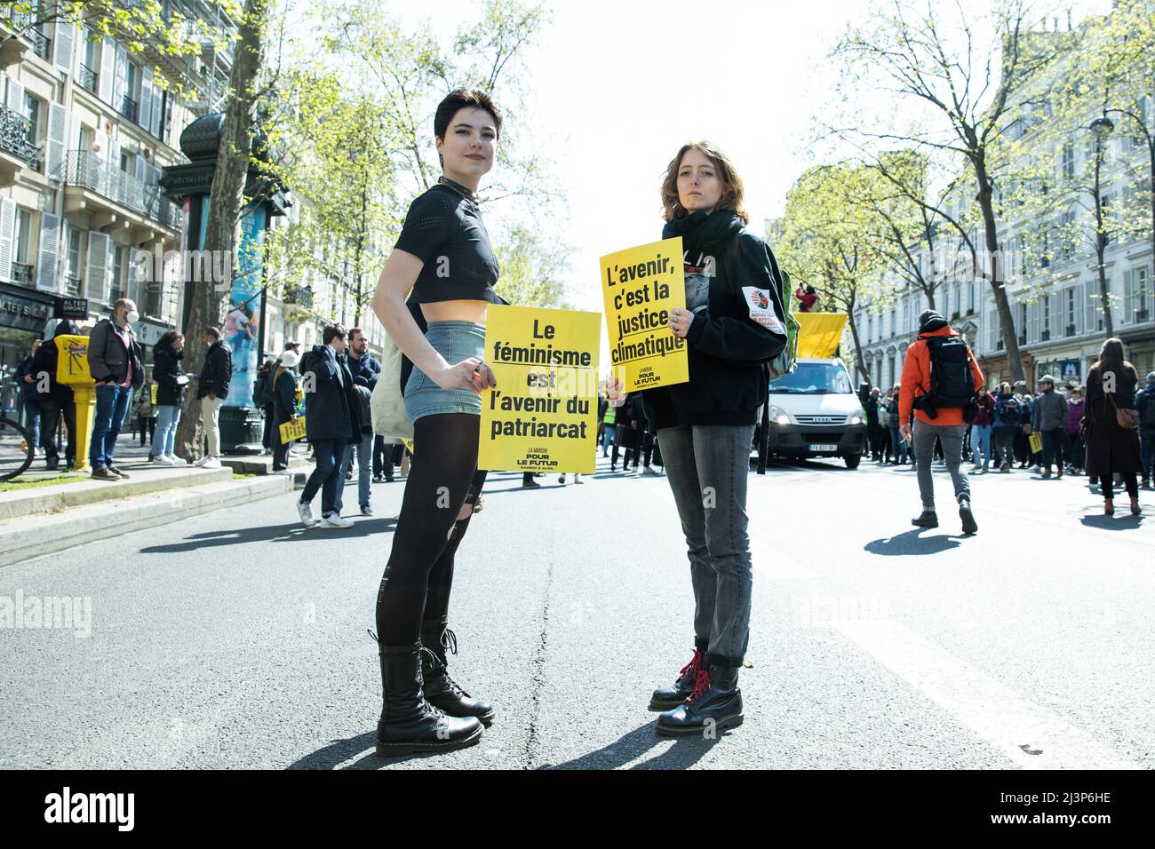 Paris, France. 09th Apr, 2022. Two demonstrators holding placards for feminism and climate justice. March for the future for the climate, social justice, equality and peace, on April 09th, 2022 in Paris, France. Photo by Christophe Michel / ABACAPRESS.COM Credit: Abaca Press/Alamy Live News Stock Photo