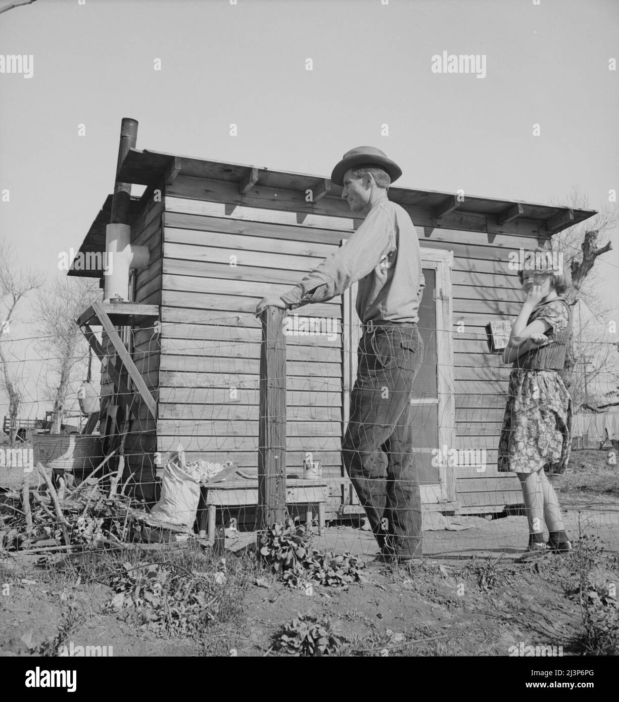 Madera County, family from near Dallas, Texas. Rent is five dollars a month. &quot;There's no future here. I've been following the work (migratory labor) but there's no chance for a fellow to get a holt hisself in this country. The last job I had is tractor driving for thirty-five cents an hour. Had that job for five months until a Filipino comes along for twenty-five cents an hour. I was raised on a cotton farm my father owned a little place back there and I'm plumb willing to leave this country for good before I get too old, If I could get the chance to farm.&quot;. Stock Photo