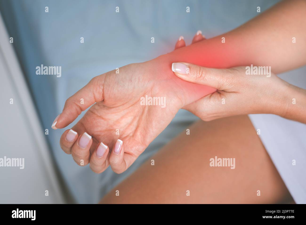 Woman with carpal tunnel syndrome. Woman feeling numbness, tingling and pain in the hand or wrist. Hand injury, arthritis or neurological disease Stock Photo