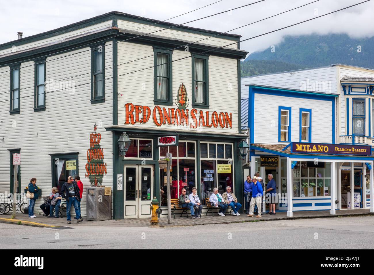 Tourists Outside The Red Onion Saloon Skagway A Famous Historic Brothel From The Gold Rush Days. Historic Building On Broadway, Skagway Stock Photo