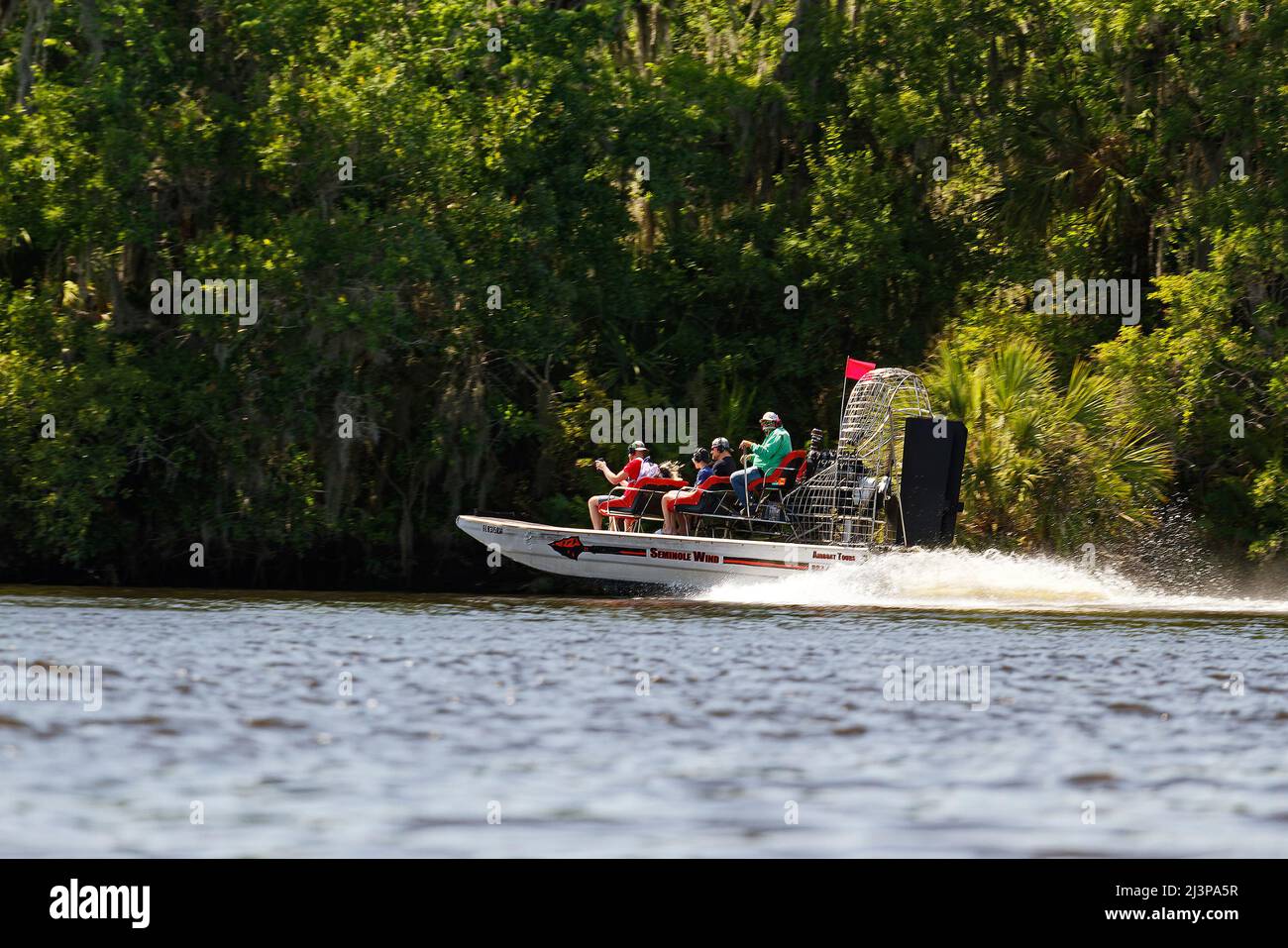 airboat moving fast, spray, people, tour, 3 rows of seats, water, noisy