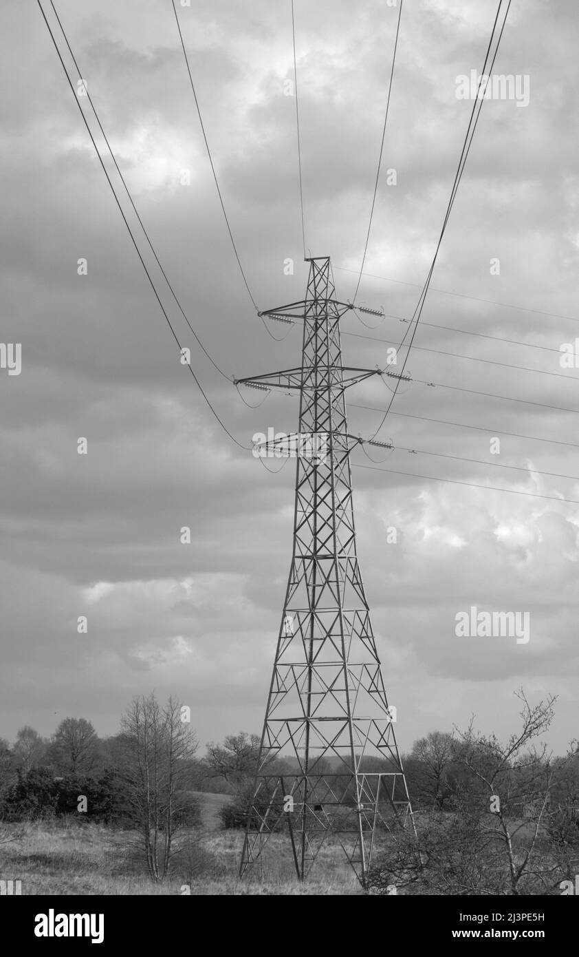 Power Generation and distribution, renewable wind turbines, overhead lines and pylons for energy transmission and distribution Stock Photo