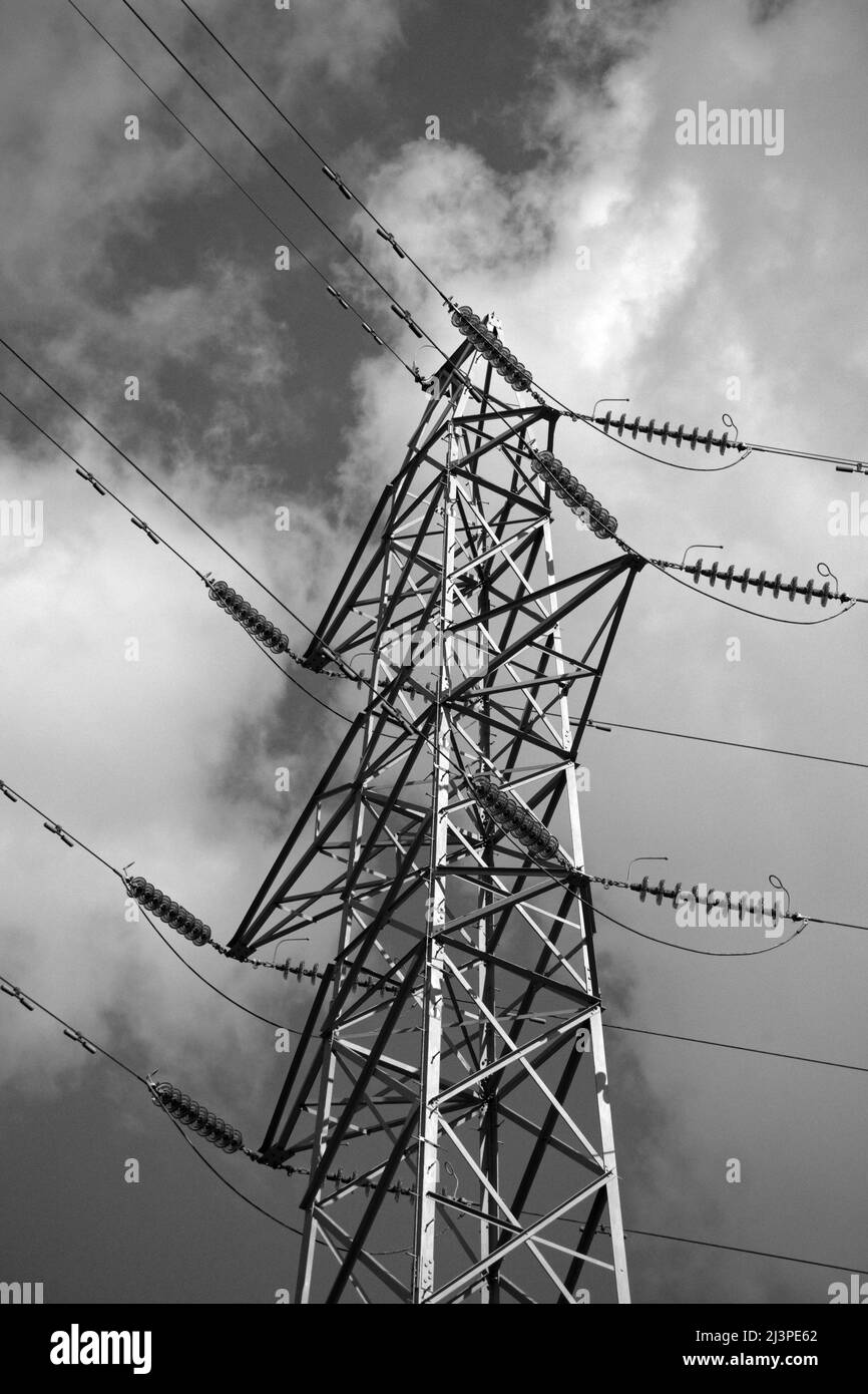 Power Generation and distribution, renewable wind turbines, overhead lines and pylons for energy transmission and distribution Stock Photo