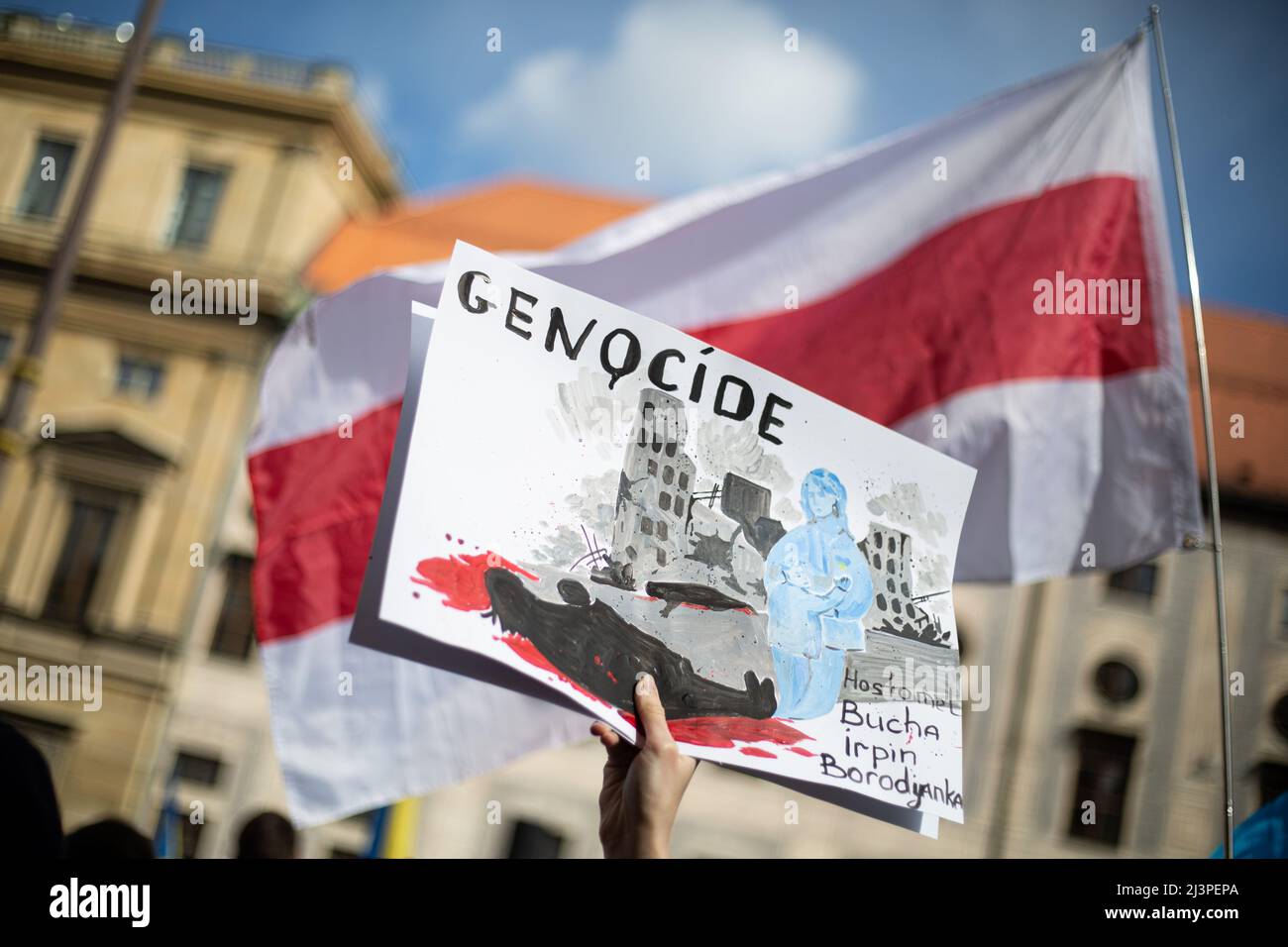 Munich, Germany. 09th Apr, 2022. Sign in front of Belarus flag: ' Genocide Hostomel, Bucha, Irpin, Borodyanka '. On April 9, 2022 thousand people gathered in Munich, Germany to protest against the Russian invasion in Ukraine and remebered of the dead of the massacre of Bucha. (Photo by Alexander Pohl/Sipa USA) Credit: Sipa USA/Alamy Live News Stock Photo