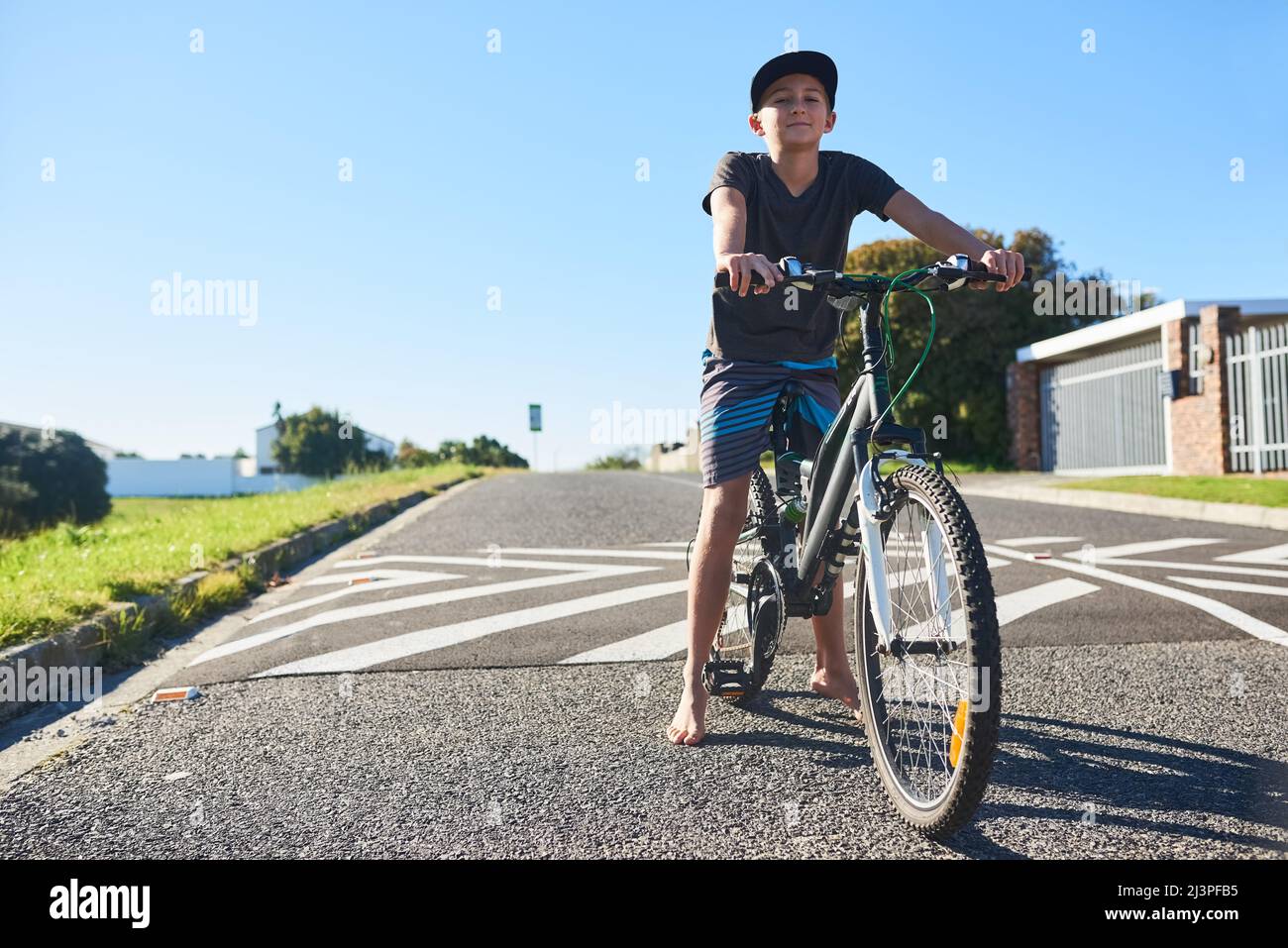 Im cycling the streets. Full length portrait of a young boy riding his bike outside. Stock Photo