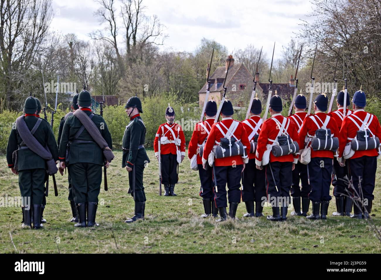 9th April 2022, Buckinghamshire, UK, re-enactors portray people of past events. Members of the Victorian Military Society form up as the 1st Battalion Middlesex known as the Diehards in red coats alongside the 13th Surrey Rifles who are Victorian rifle volunteers. Stock Photo