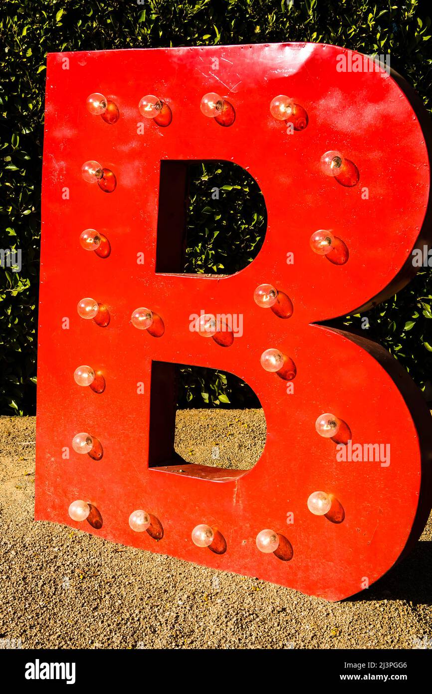 A huge red B, the symbol of the Birba restaurant in Palm Springs, California. The letter is larger than life and illuminated with 21 small, round, lig Stock Photo