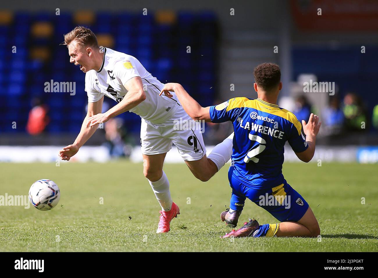 London, UK. 09th Apr, 2022. Scott Twine of MK Dons (L) is tackled by Henry Lawrence of AFC Wimbledon (R). EFL Skybet football league one match, AFC Wimbledon v MK Dons at Plough Lane in London on Saturday 9th April 2022. this image may only be used for Editorial purposes. Editorial use only, license required for commercial use. No use in betting, games or a single club/league/player publications. pic by Steffan Bowen/Andrew Orchard sports photography/Alamy Live news Credit: Andrew Orchard sports photography/Alamy Live News Stock Photo