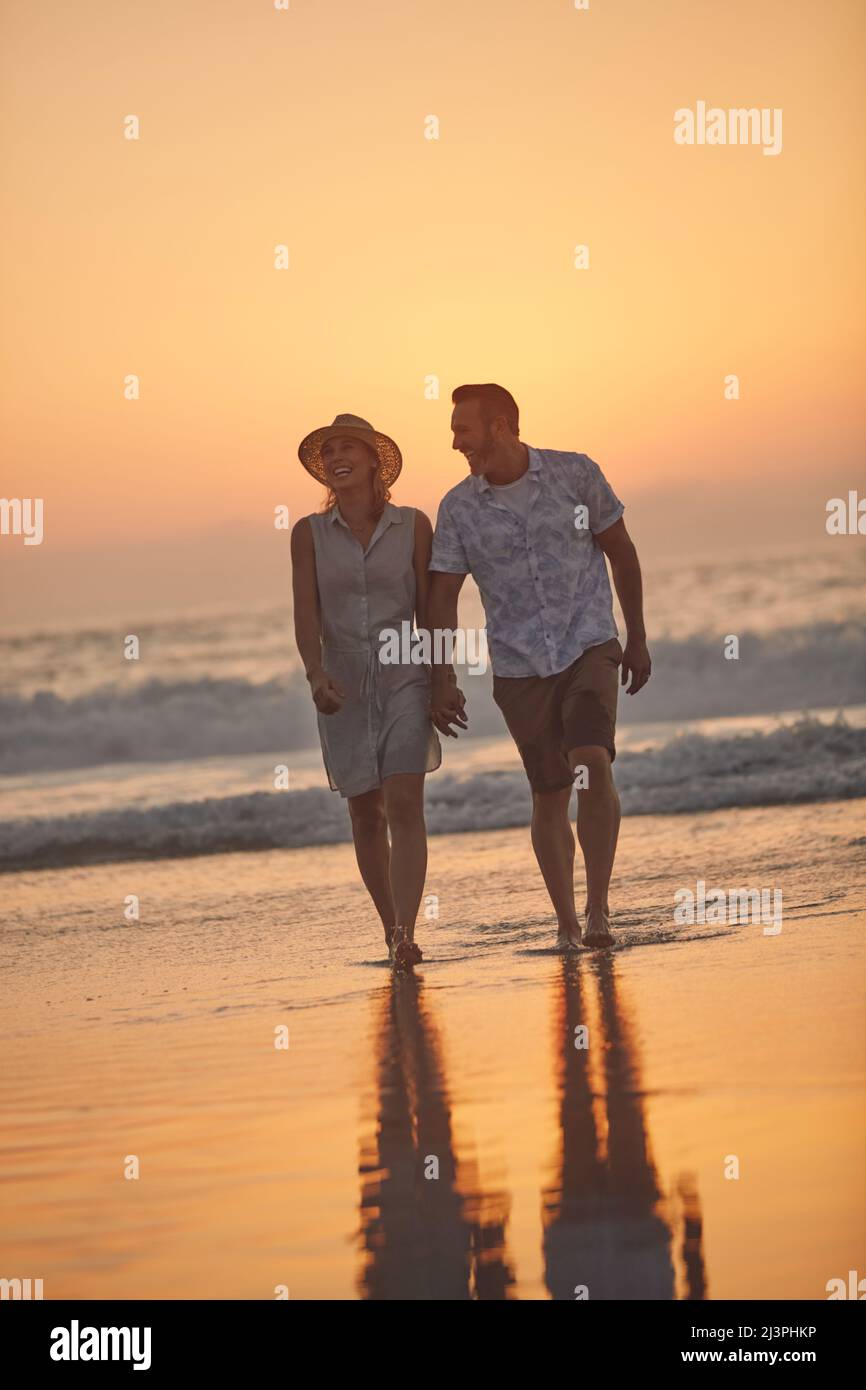 You make me want to do those silly things for love. Shot of an affectionate  mature couple taking a walk on the beach Stock Photo - Alamy