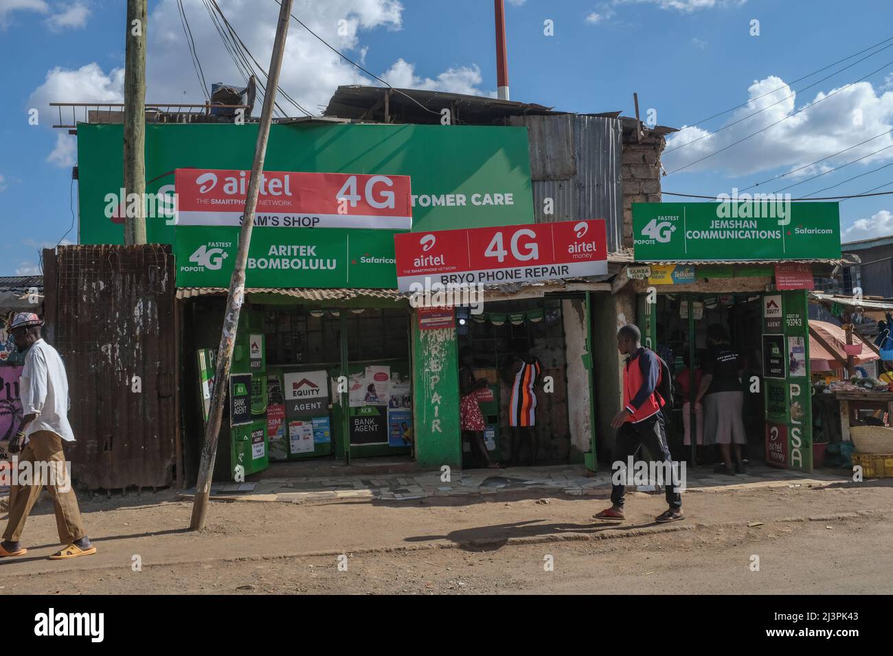 Nairobi, Kenya. 9th Apr, 2022. Locals walk past mobile money service