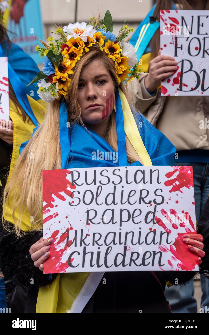 Whitehall, London, UK. 9th Apr, 2022. Protesters demonstrated against the deaths of Ukraine civilians during the war with Russia by playing dead, with some having their hands behind their backs replicating how some bodies have been found in the streets. Female with bloodied placard Stock Photo