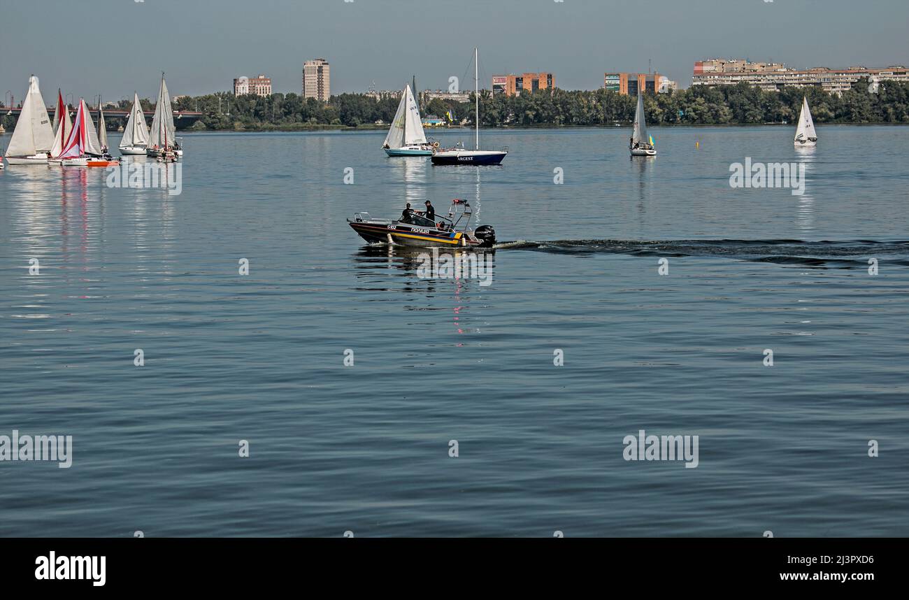 Dnepropetrovsk, Ukraine - 09.11.2021: Water police patrol the parade of sailing yachts on the Dnieper river. Stock Photo