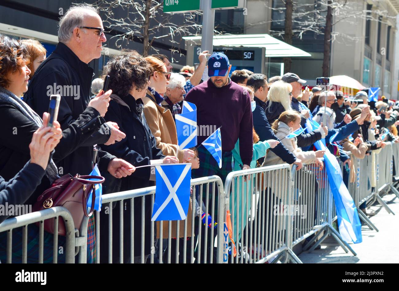 People are seen holding Scottish flag during the world's largest pipe and drum parade to celebrate Scottish Tartan Day on April 9, 2022 in New York Ci Stock Photo