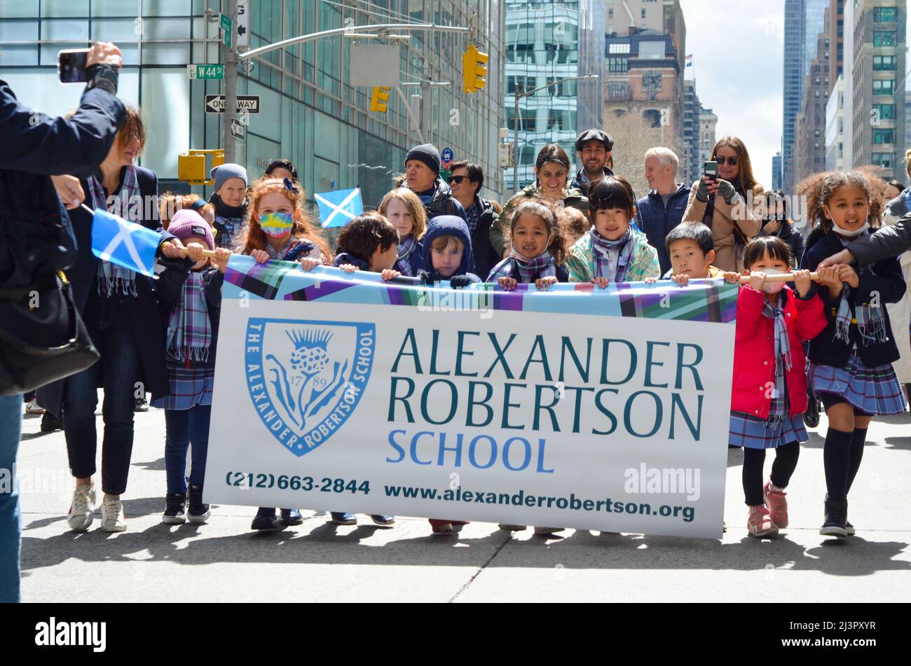Young participants of Alexander Robertson School march up Sixth Avenue during the world's largest pipe and drum parade to celebrate Scottish Tartan Da Stock Photo