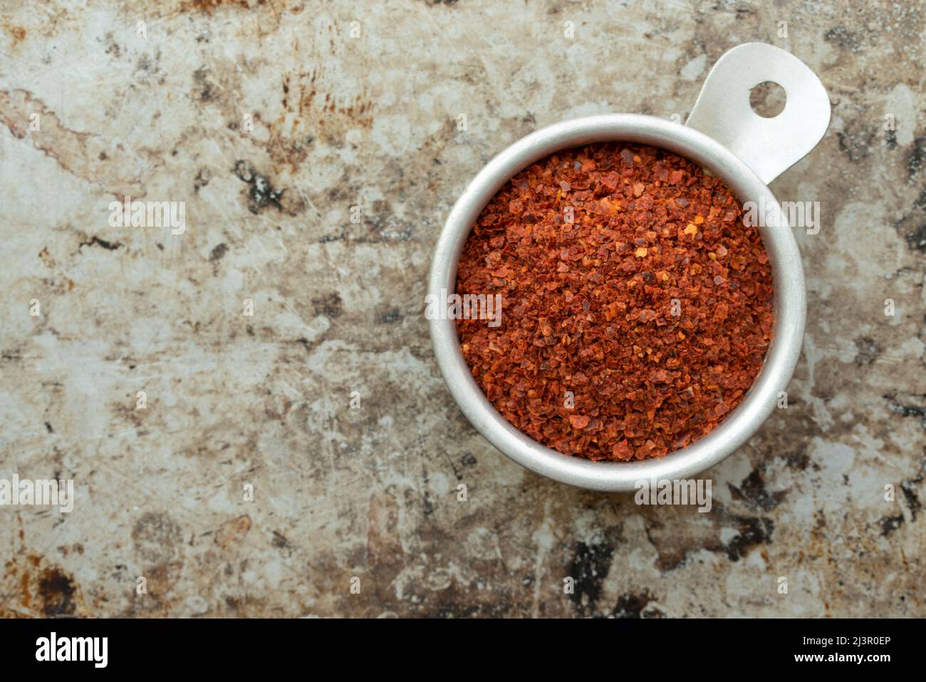 Aleppo Pepper Flakes in a Measuring Cup Stock Photo