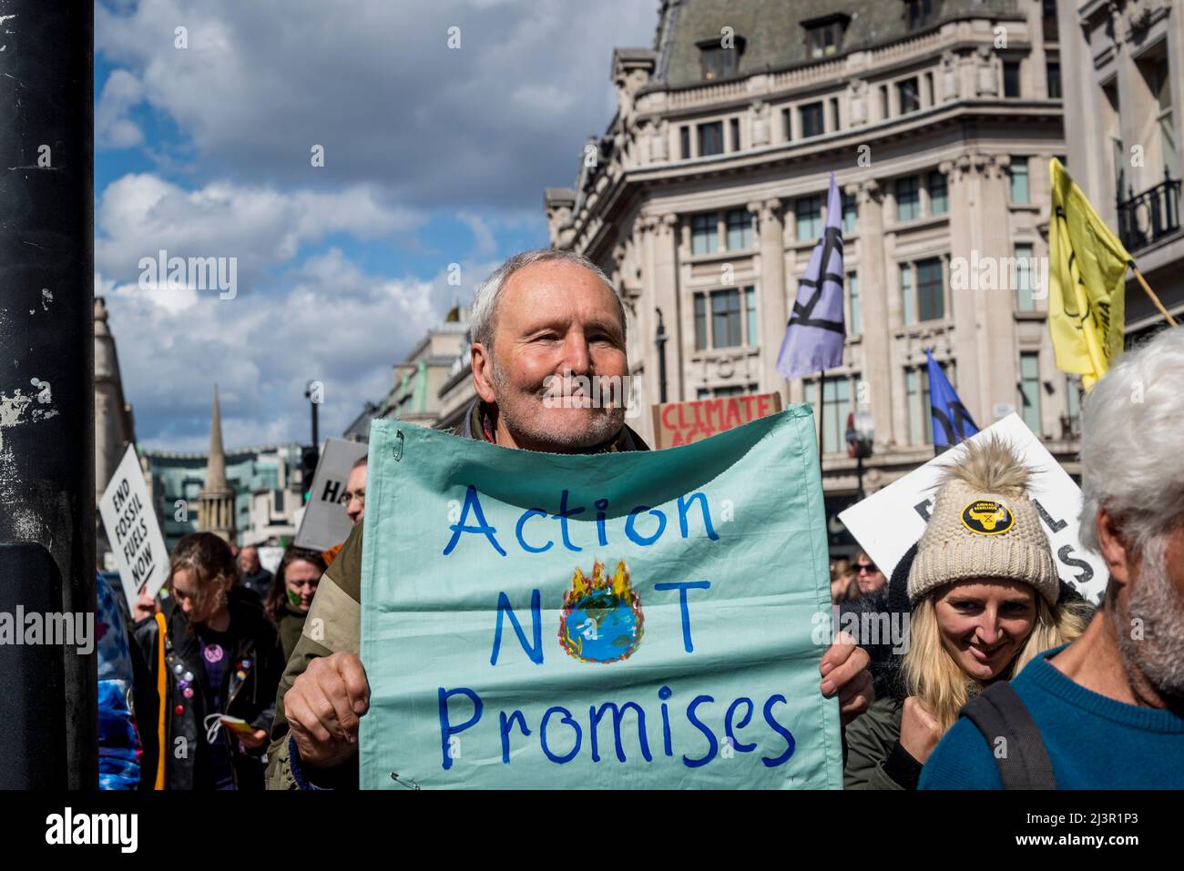 Action Not promises placard, We Will Not Be Bystanders, an Extinction Rebellion protest that fights for climate justice, in central London, 09.04.2022, London, England, UK Stock Photo