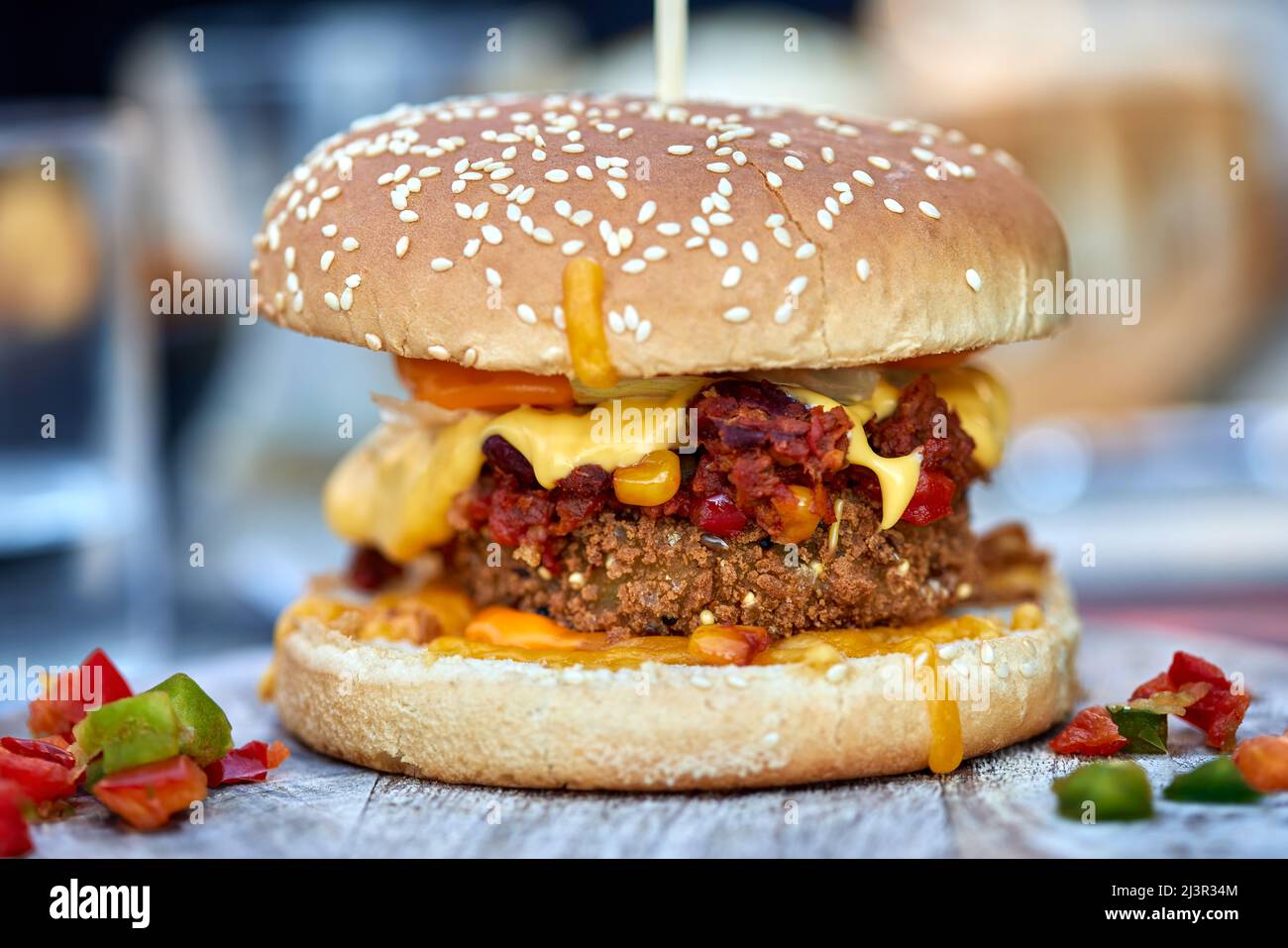 100% Vegetarian cheeseburger with different kind of vegetables on a wooden table Stock Photo