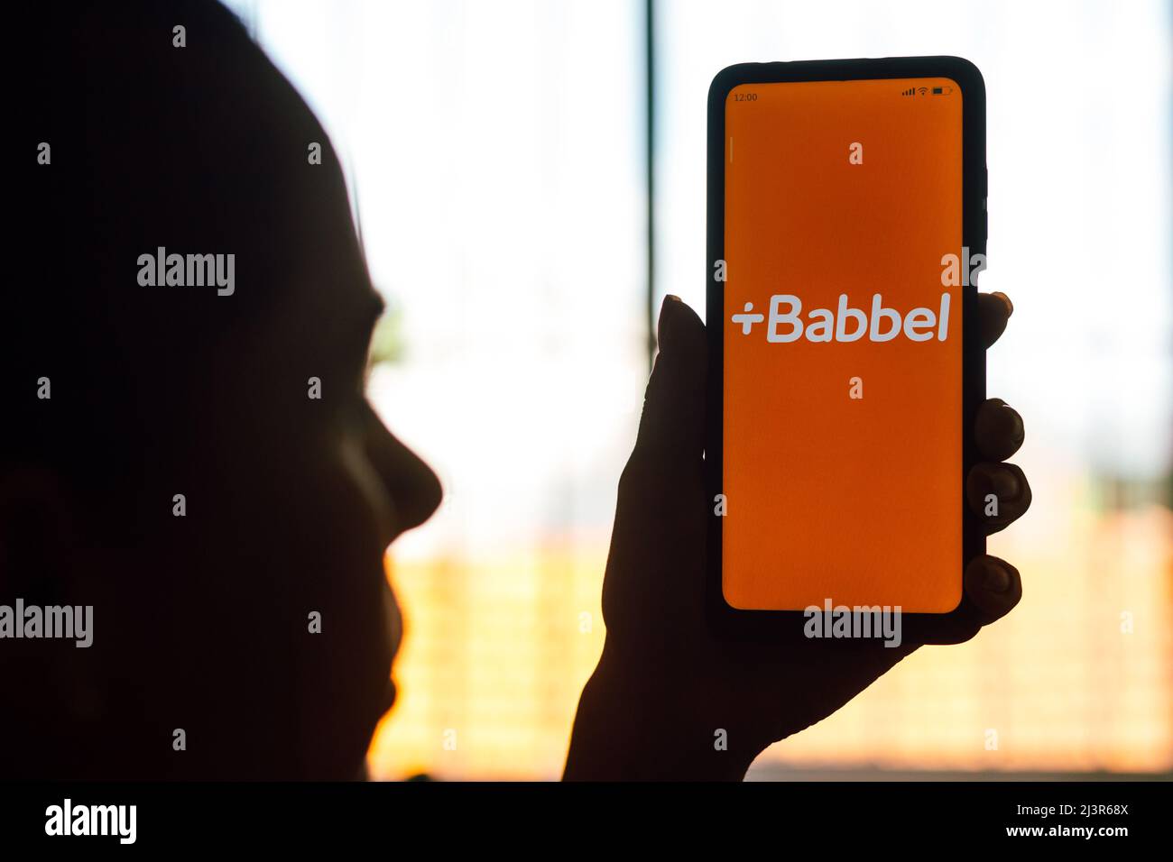 Brazil. 09th Apr, 2022. In this photo illustration, a woman's silhouette holds a smartphone with the Babbel logo displayed on the screen. (Photo by Rafael Henrique/SOPA Images/Sipa USA) Credit: Sipa USA/Alamy Live News Stock Photo