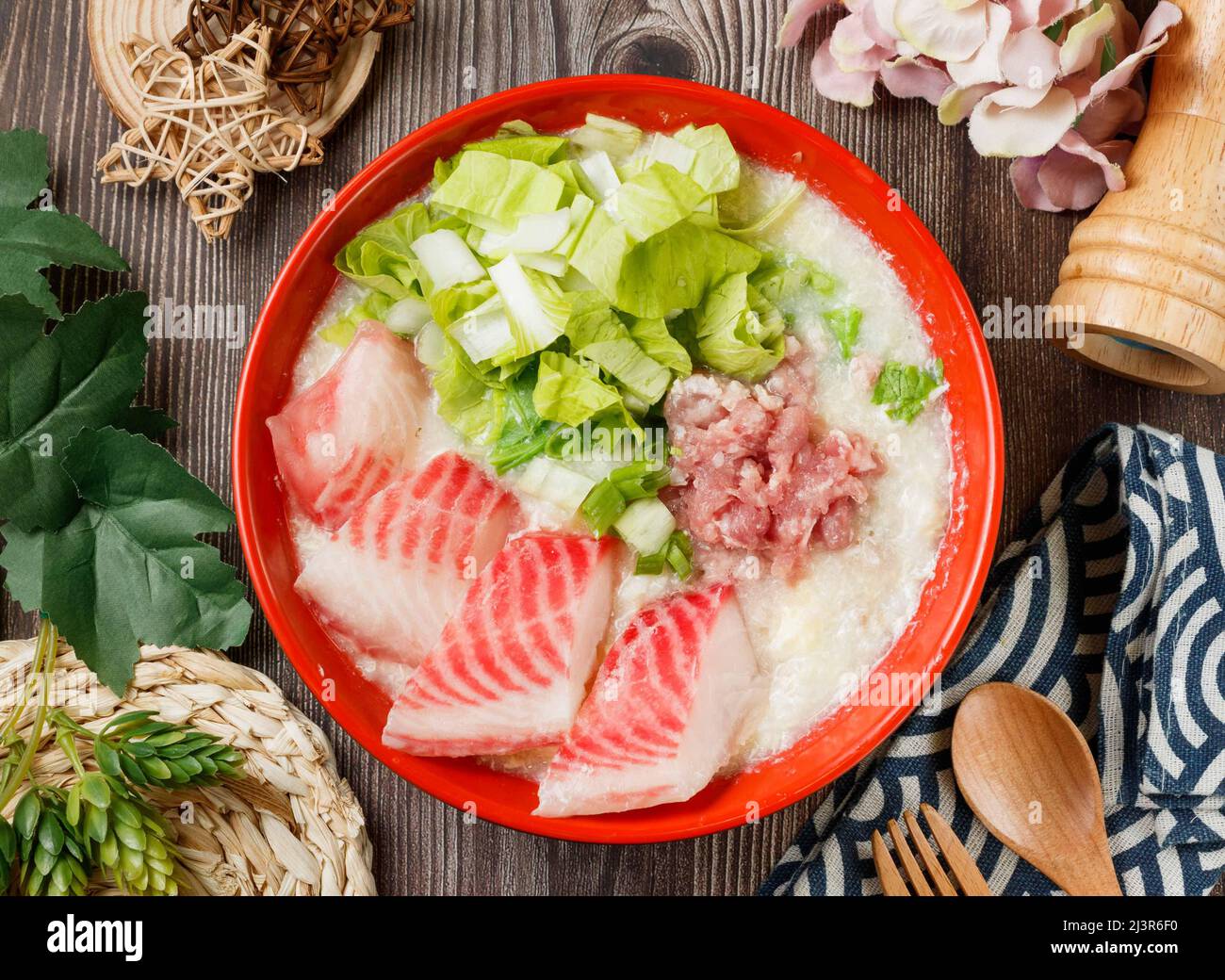 Fish fillet lean meat porridge in a bowl top view on wooden table taiwan food Stock Photo