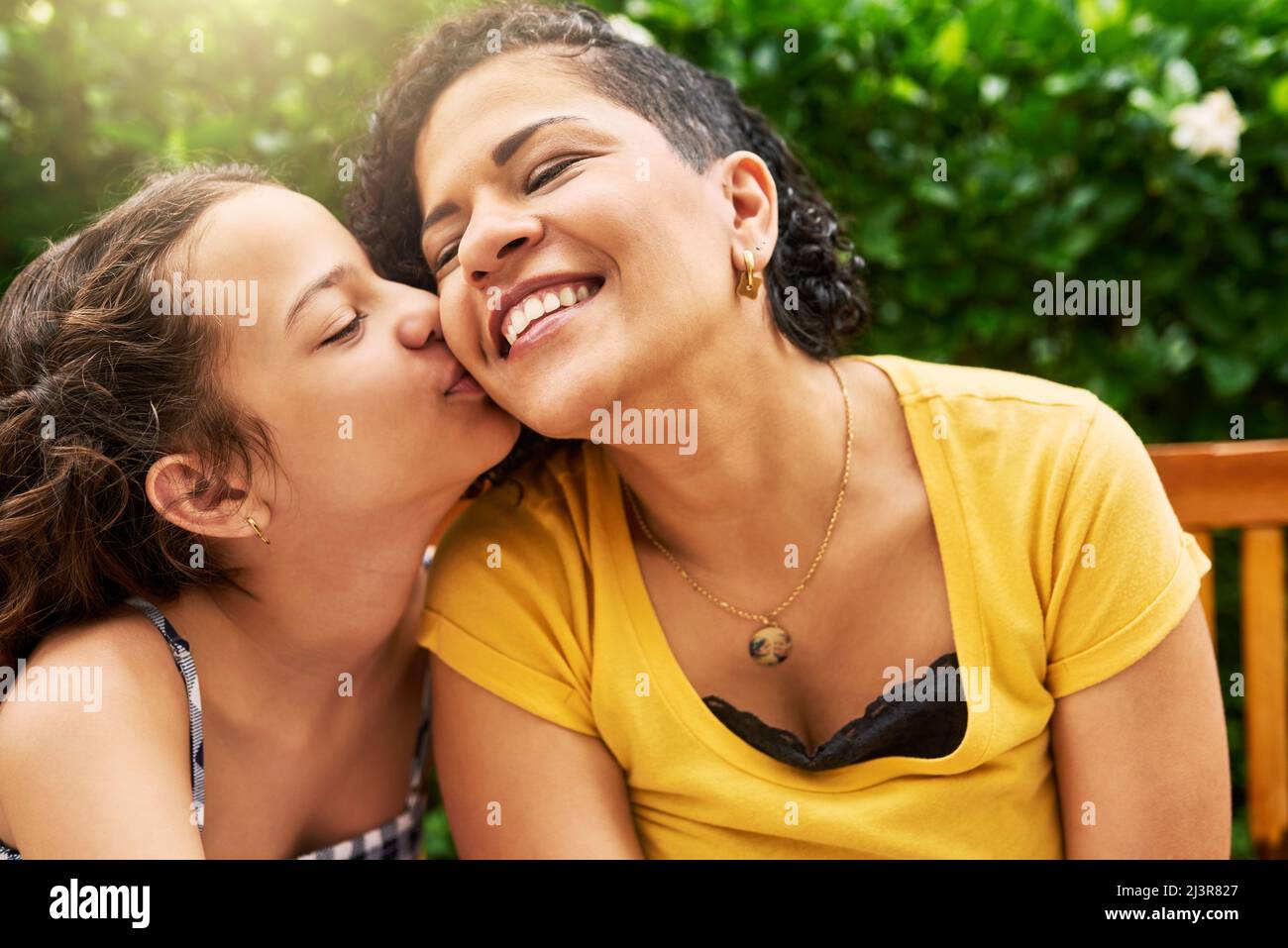Children kissing mom in outdoor park hi-res stock photography and images image