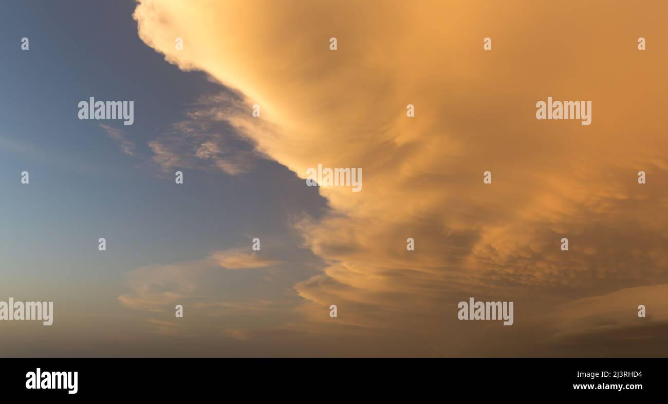 Contrasting red clouds against a blue sky  Stock Photo