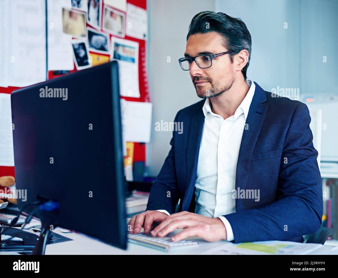 I like what Im seeing. Shot of a businessman working at his desk. Stock Photo