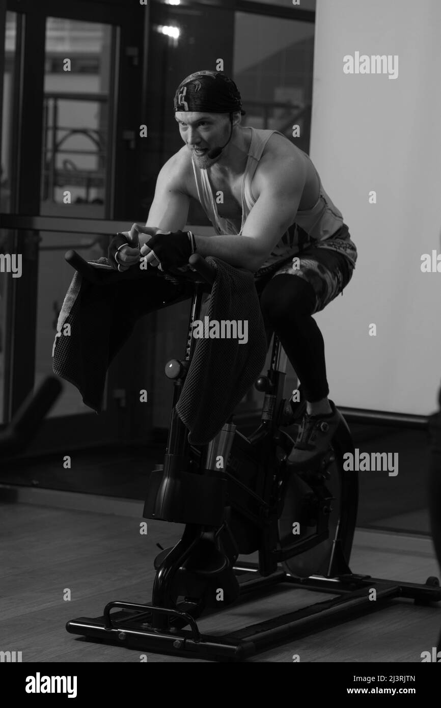 Athlete a on bike bicycle up trainer pumped legs training gym fit, for