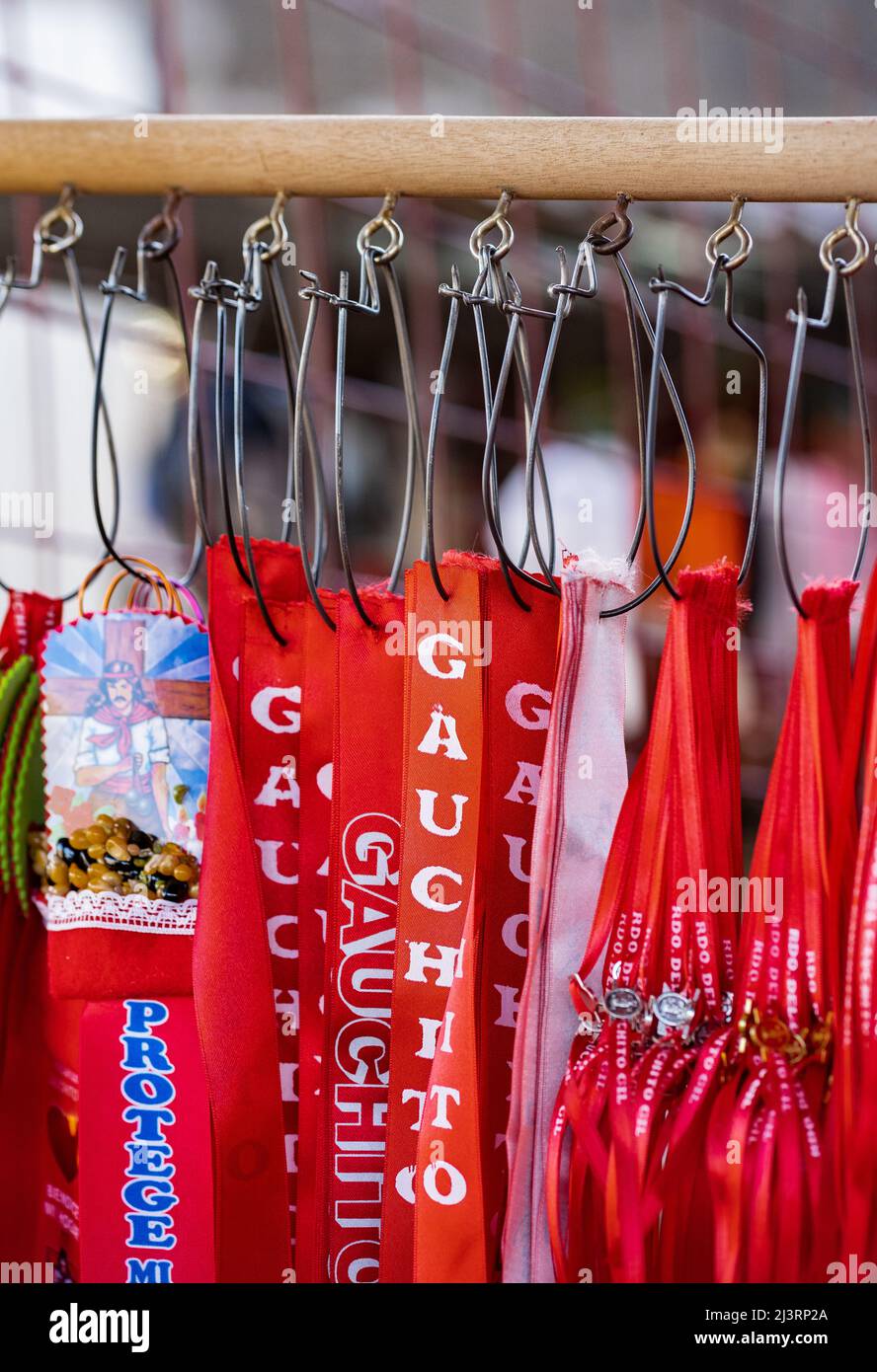 MERCEDES, CORRIENTES, ARGENTINA - NOVEMBER 22, 2021: Close up of red ribbons with the copy 'Gauchito Gil' in a souvenirs shop from the shrine to Gauch Stock Photo