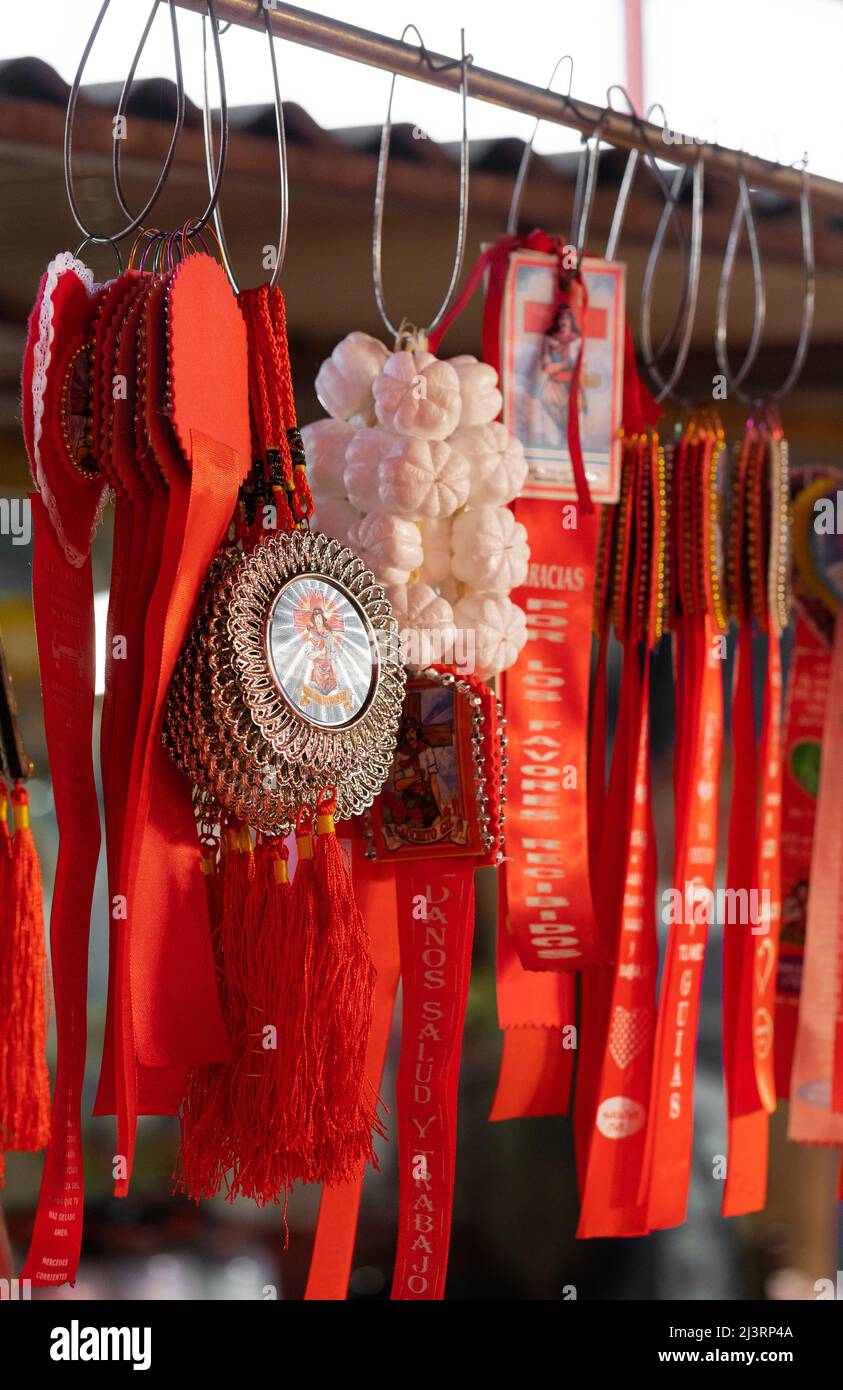 MERCEDES, CORRIENTES, ARGENTINA - NOVEMBER 22, 2021: Close up of souvenirs of Gauchito Gil with red ribbon. The Gauchito Gil (literally 'Little Gaucho Stock Photo