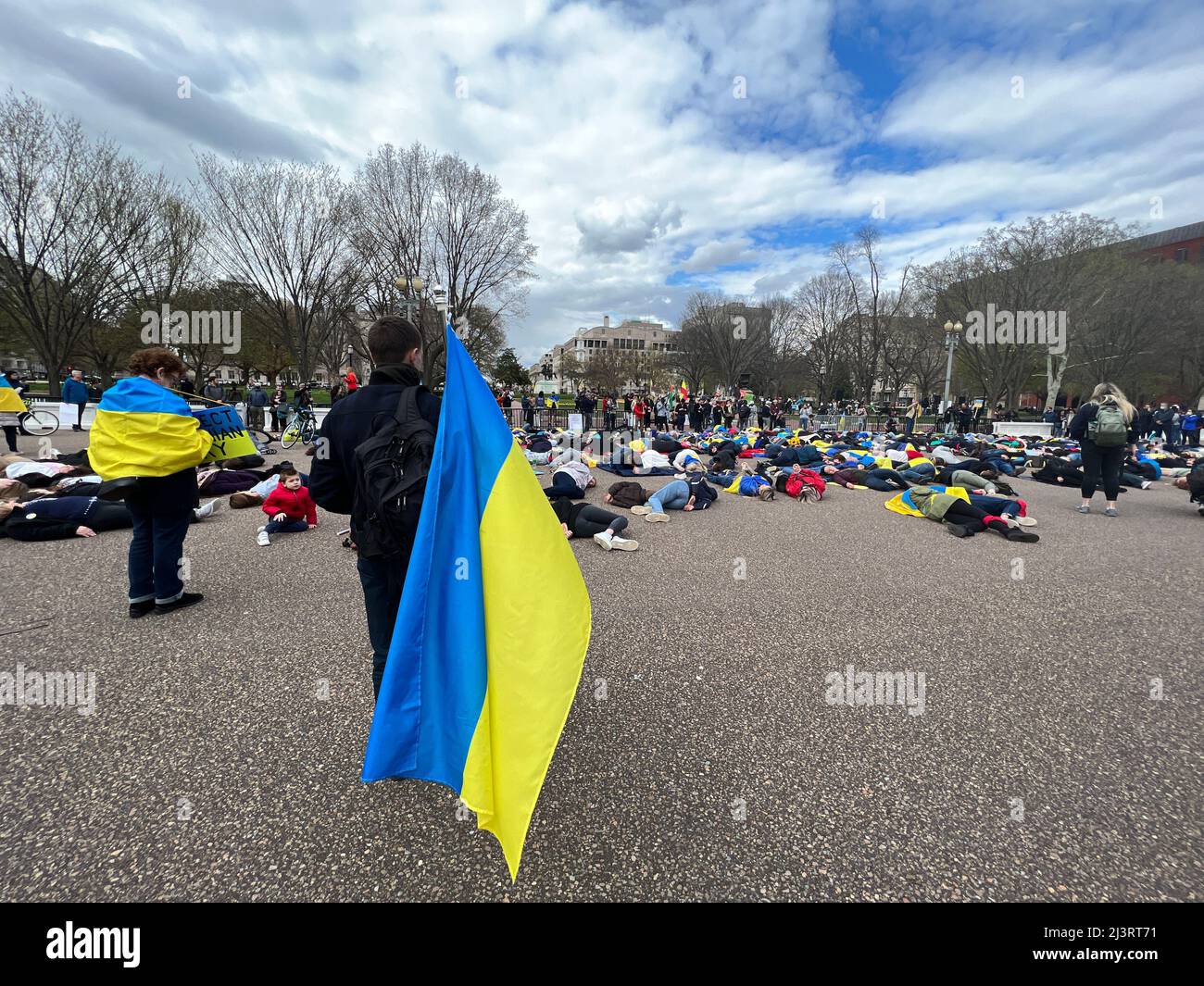 09 April 2022 Washington DC USA Supporters for Ukraine stage demonstration in front of The White house lying on the ground to simulate the dead as names of the dead were dead a!oud. Stock Photo