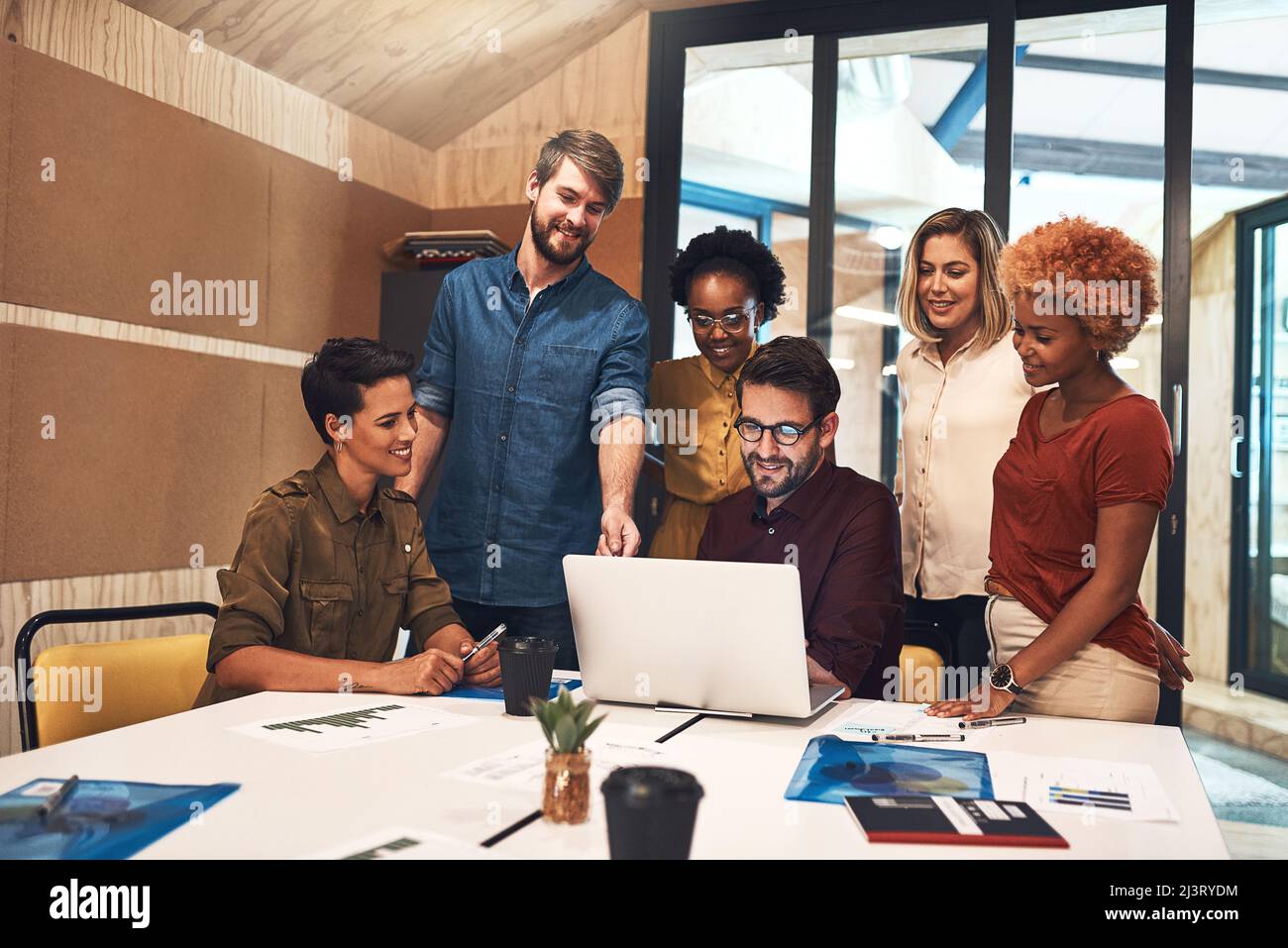 Nothing better than a big plan coming together. Shot of a diverse group of businesspeople working together on a laptop in an office. Stock Photo