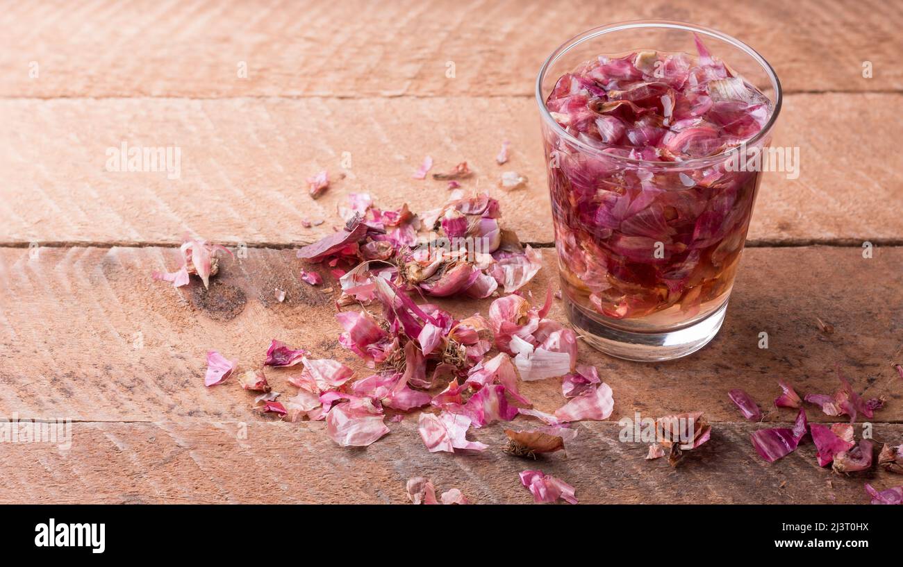 process of making onion peel fertilizer, onion skin soaked in water with scattered pieces, food waste used as natural fertilizer, kitchen and househol Stock Photo