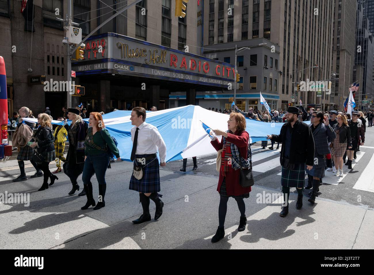New York, USA. 09th Apr, 2022. Scottish-Americans carry a large Scottish flag at the Tartan Day Parade in New York, New York, on April 9, 2022. (Photo by Gabriele Holtermann/Sipa USA) Credit: Sipa USA/Alamy Live News Stock Photo