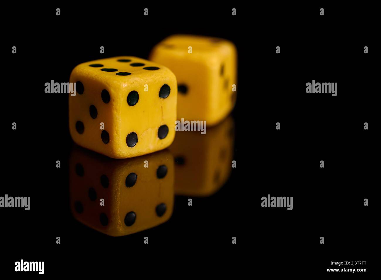 Gambling. Two dice on a black background with reflection Stock Photo