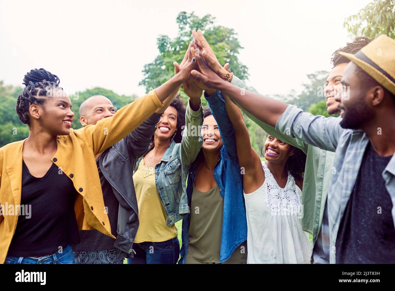 Were each others motivation. Shot of a group of friends reaching for a high five. Stock Photo