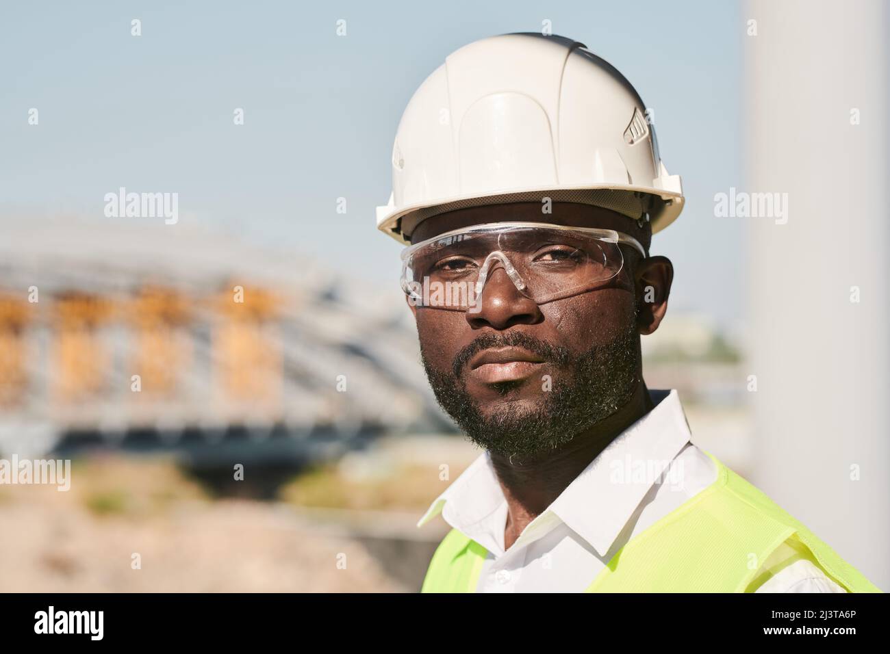 Portrait of young male engineer posing at construction site Stock Photo