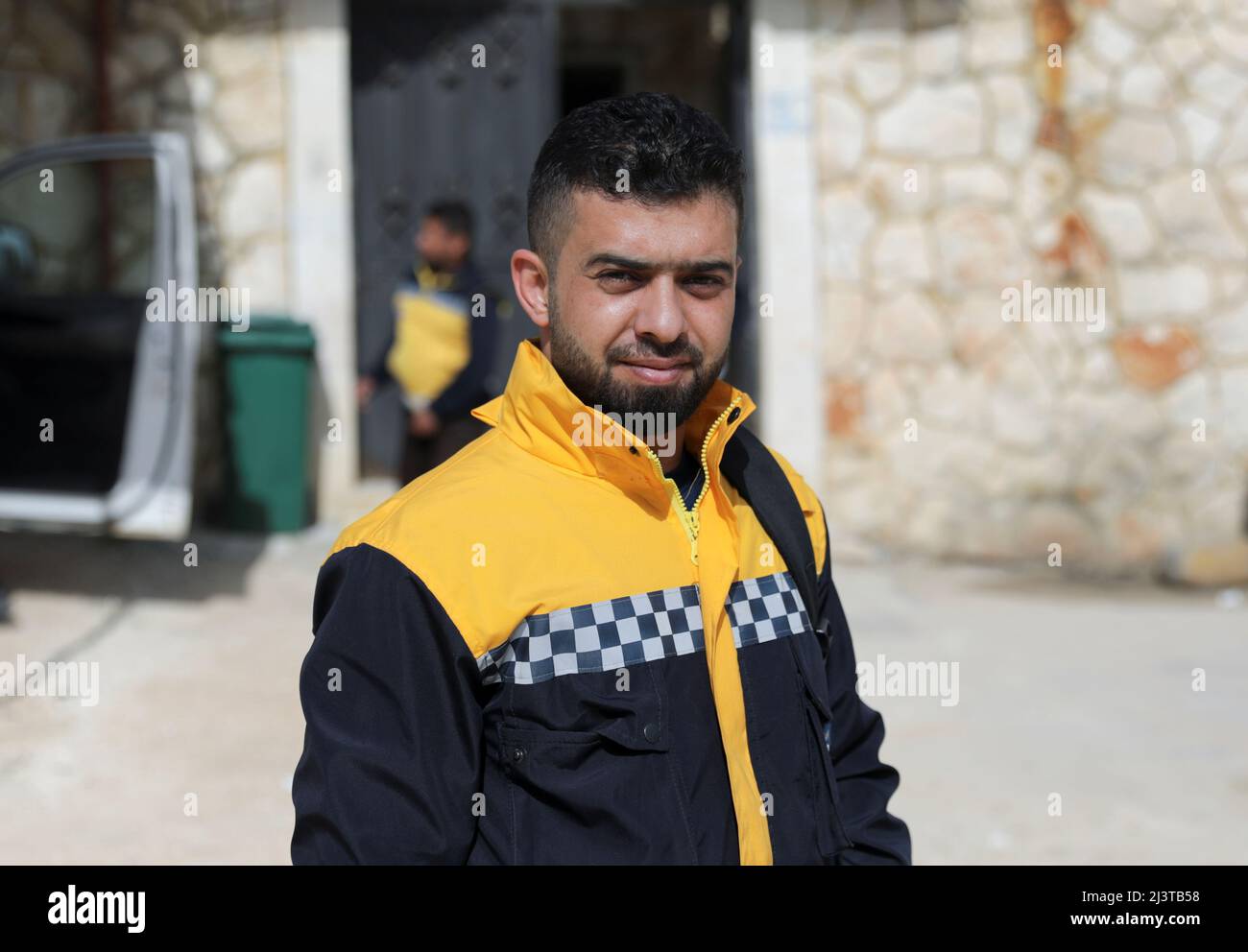 Hamid Ketteny, a civil defence rescue worker who says he carried to a nearby medical point the bodies of six children who were killed when poison gas was dropped in the town of Khan Sheikhoun in 2017, poses as he stands outside a civil defence center on the outskirts of the rebel-held Idlib, Syria April 2, 2022. Picture taken April 2, 2022. REUTERS/Khalil Ashawi Stock Photo