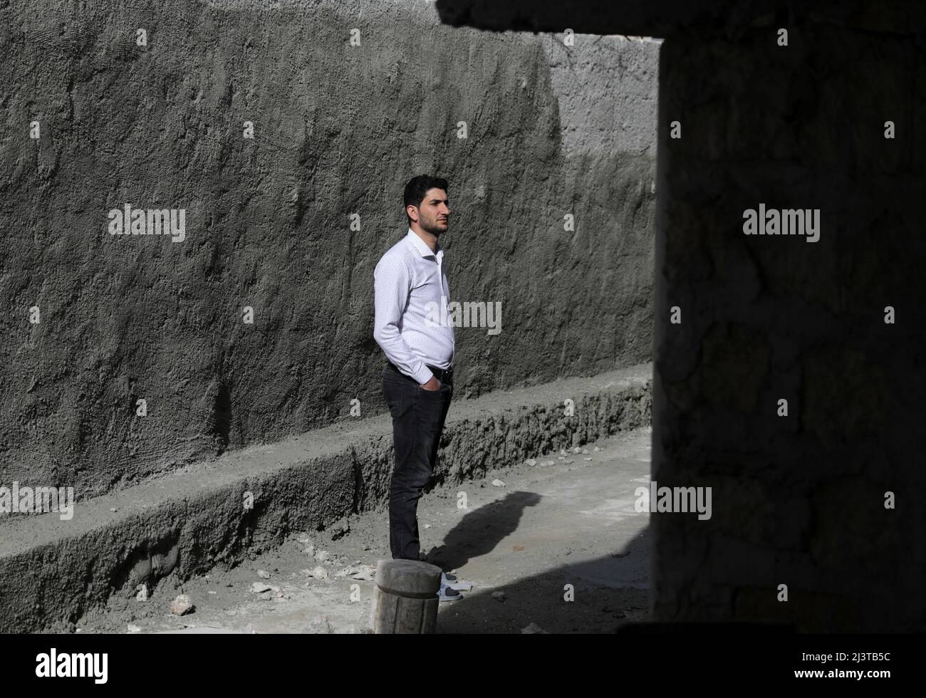Abdel Hamid al-Youssef, an internally displaced man who says his wife and infant twins were killed when poison gas was dropped on their home town of Khan Sheikhoun in 2017, stands outside his house in the rebel-held town of Sarmada in Idlib province, Syria April 1, 2022. Picture taken April 1, 2022. REUTERS/Khalil Ashawi Stock Photo