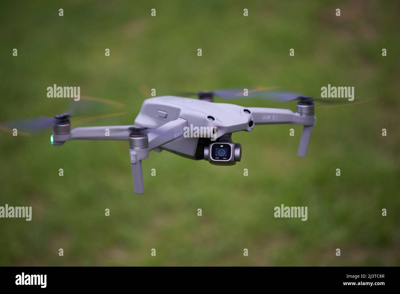 Nürtingen, Germany - June 26, 2021: Modern Dji air 2s drone. Gray multicopter with sensors and 1 Inch camera. Green meadow depth of field. High angle Stock Photo