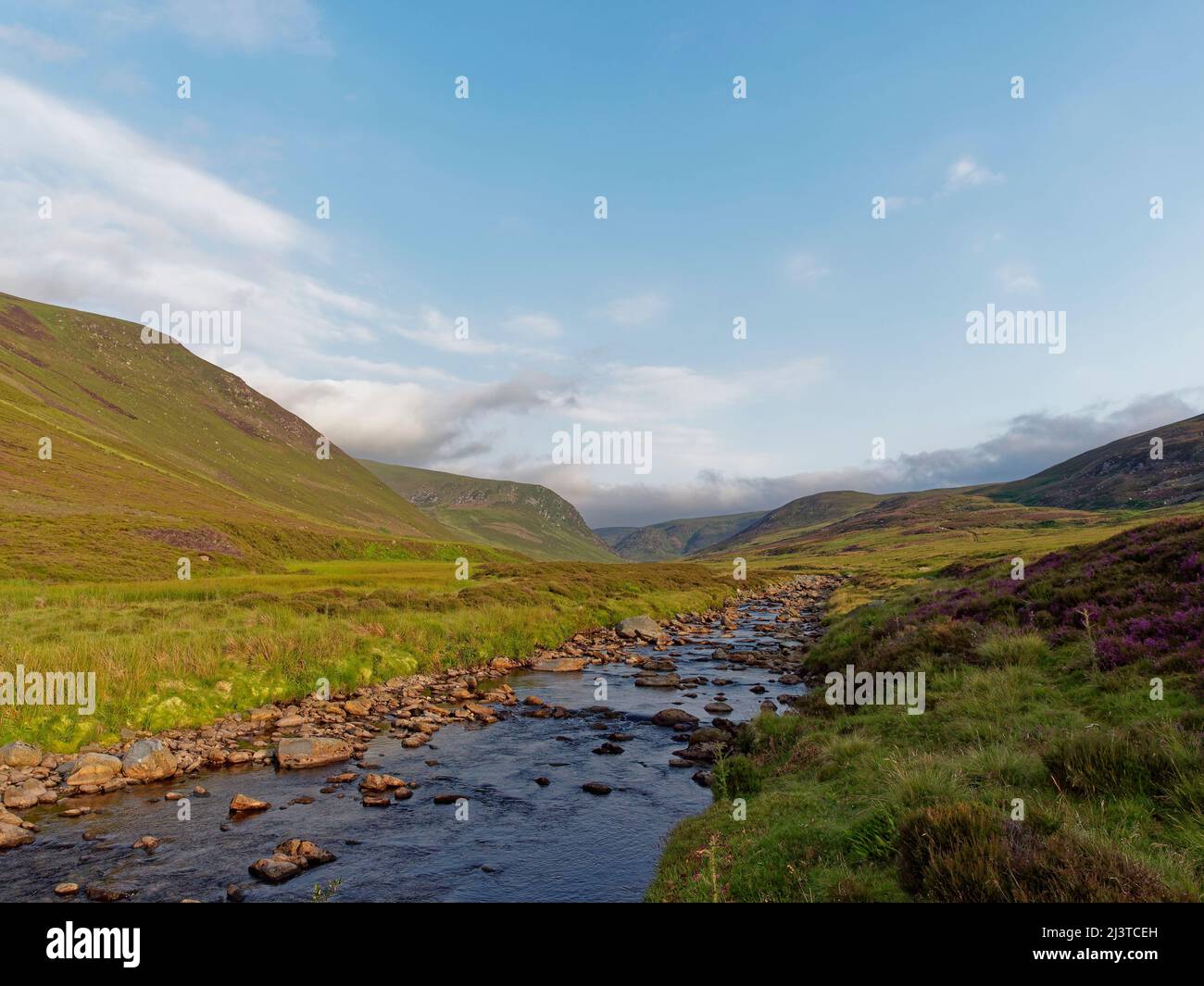 Distant Clouds building over the Hills of Glen Lethnot over the Waters of Saugh stream running gently through the Valley. Stock Photo