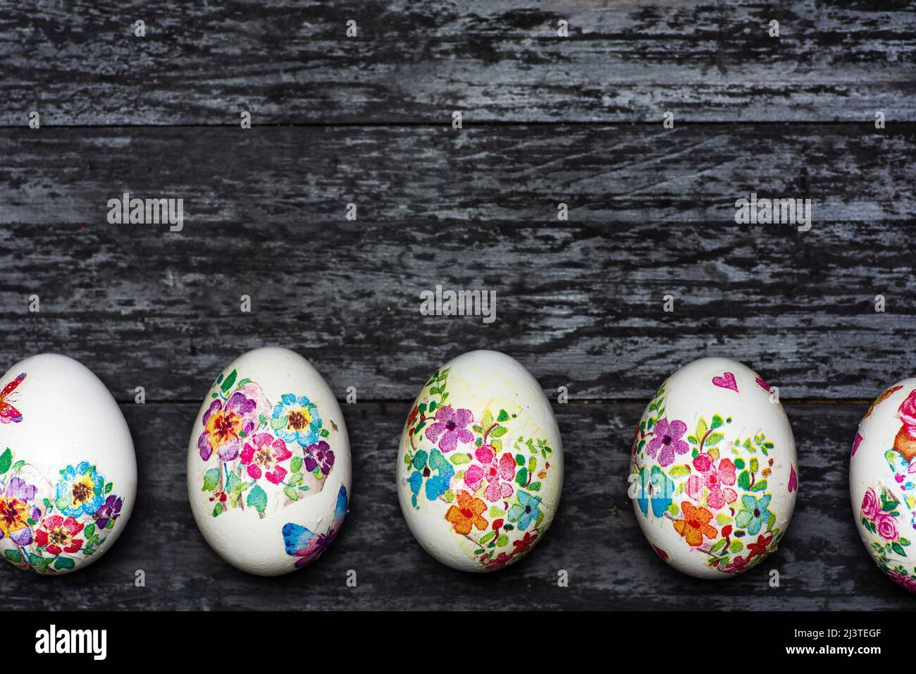 White Easter eggs made with decoupage technique with floral motifs on a