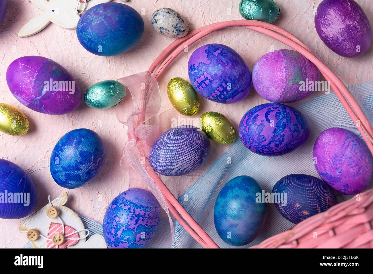 Purple and blue Easter eggs with on a pastel background. Stock Photo