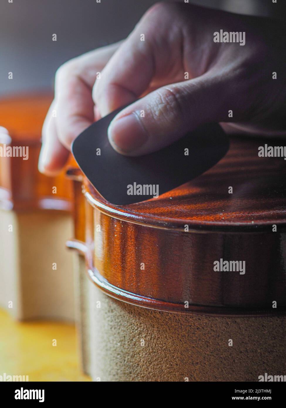 luthier working on a new violin in his workshop Stock Photo