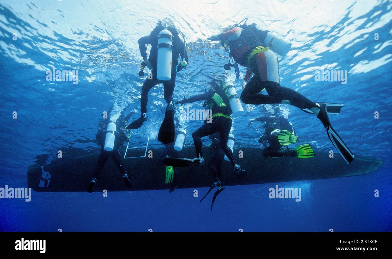 A group scuba diver under the dive boat, Ari Atoll, Maldives, Indian ocean, Asia Stock Photo