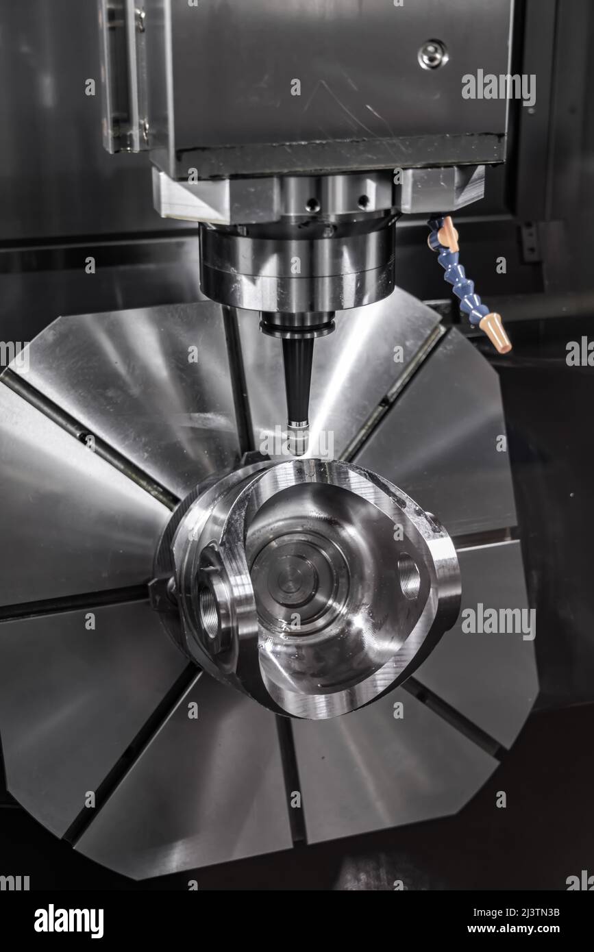 Metalworking CNC milling machine. Cutting metal modern processing technology. Small depth of field. Warning - authentic shooting in challenging condit Stock Photo